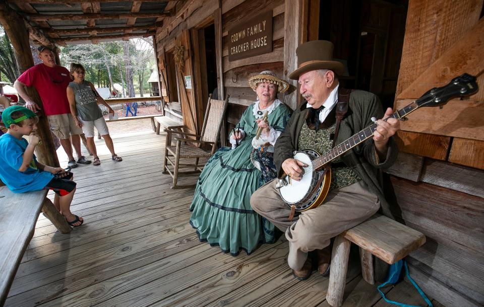 Mary Lee Sweet, left, and her husband, Frank, dressed in late 1800s attire and played “Ol’ Suzanna” on the porch of the Godwin Family Cracker House as hundreds of Marion County students took part in Ocali Country Days in 2018.