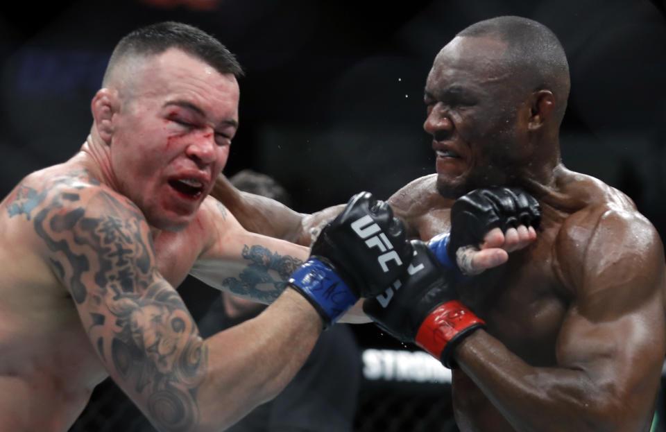 LAS VEGAS, NEVADA - DECEMBER 14:  Colby Covington (L) takes a punch from UFC welterweight champion Kamaru Usman in their welterweight title fight during UFC 245 at T-Mobile Arena on December 14, 2019 in Las Vegas, Nevada. Usman retained his title with a fifth-round TKO.  (Photo by Steve Marcus/Getty Images)
