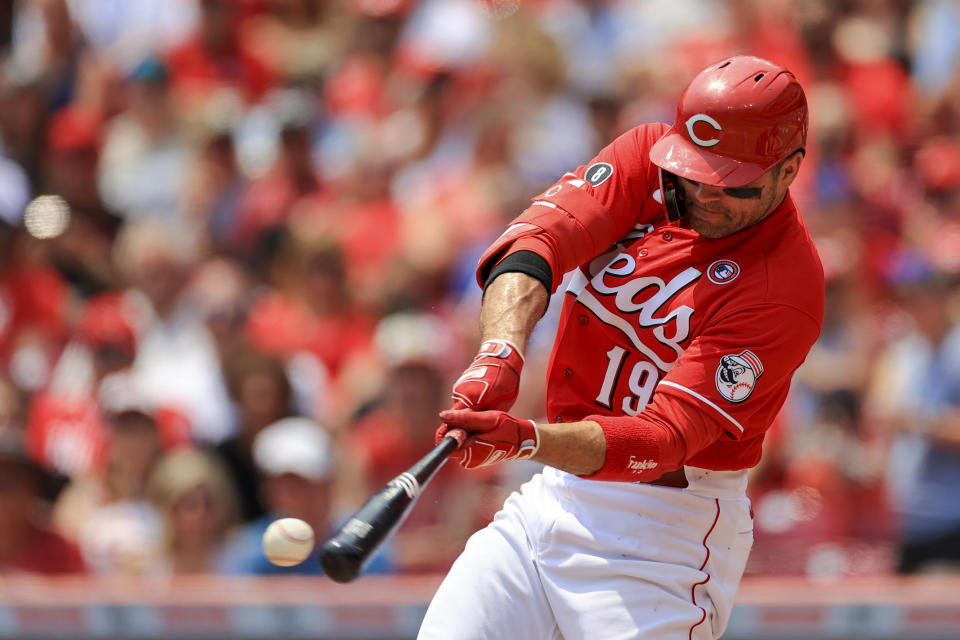 Cincinnati Reds' Joey Votto hits a single during the first inning of a baseball game against the Chicago Cubs in Cincinnati, Sunday, July 4, 2021. (AP Photo/Aaron Doster)