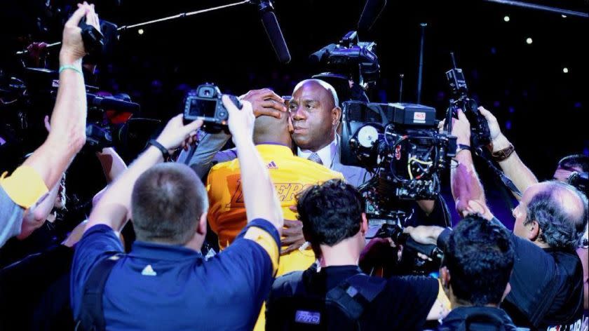 Kobe Bryant and Magic Johnson embrace before Bryant's final game at Staples Center on April 13, 2016.