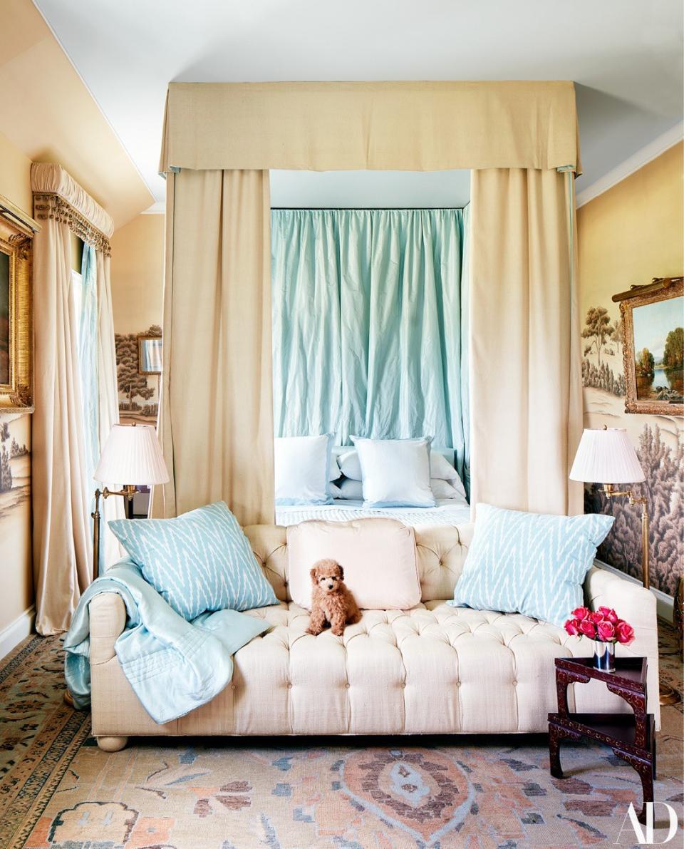 Toy poodle Minnie sits on a custom sofa by Jaydan Interiors in the master bedroom.