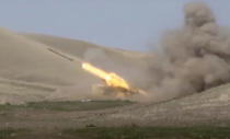 In this image taken from footage released by Azerbaijan's Defense Ministry on Sunday, Sept. 27, 2020, an Azerbaijan's rocket launches from missile system at the contact line of the self-proclaimed Republic of Nagorno-Karabakh, Azerbaijan. Fighting between Armenian and Azerbaijani forces over the disputed separatist region of Nagorno-Karabakh continued on Monday morning after erupting the day before, with both sides blaming each other for resuming the attacks. (Azerbaijan's Defense Ministry via AP)