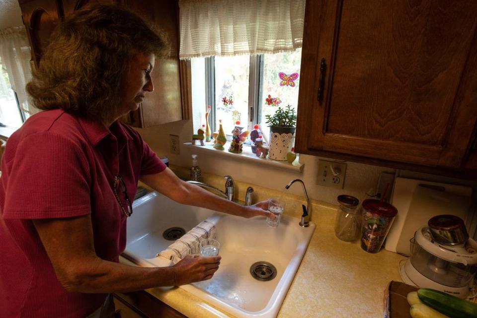 Martha Lorenzo draws drinking water made using hydropanels, which trap water vapor from the air, at her home in Keyes, Calif., on Wednesday, August 3, 2022.