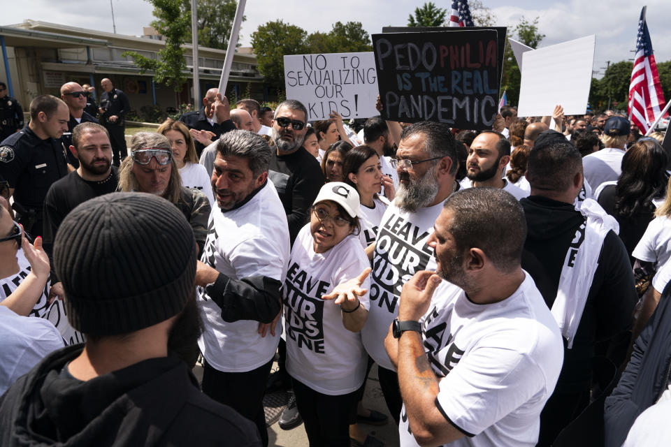 People protesting a planned Pride month assembly argue with counterprotestors outside Saticoy Elementary School in Los Angeles, Friday, June 2, 2023. Police officers separated groups of protesters and counter protesters Friday outside the elementary school that has become a flashpoint for Pride month events across California. (AP Photo/Jae C. Hong)