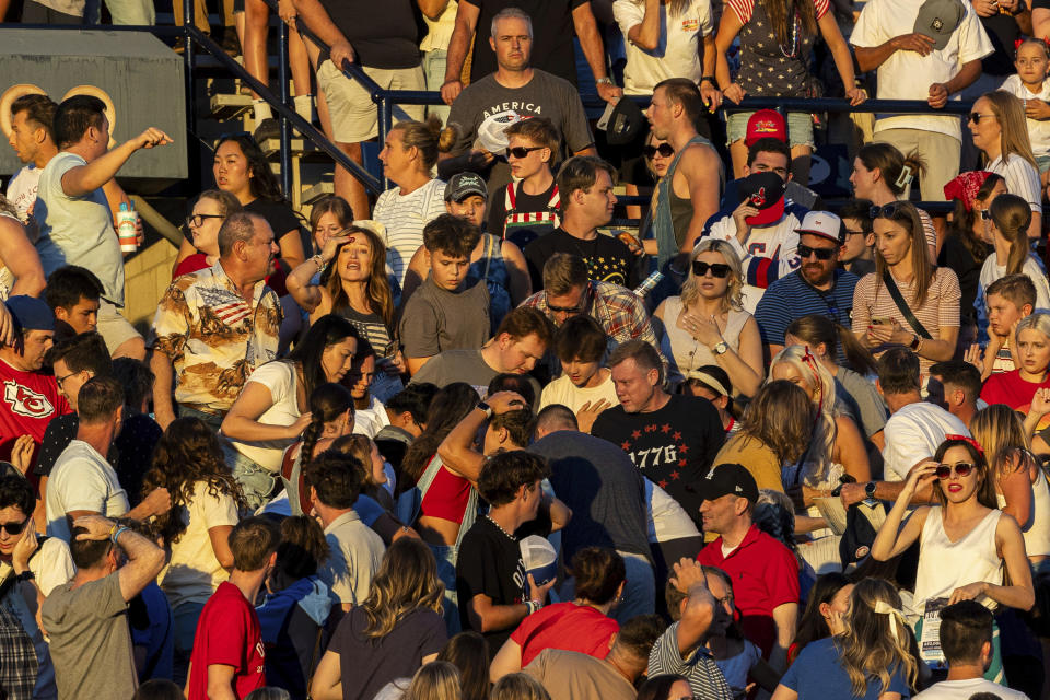 The crowd reacts after an errant firework exploded among attendees during Stadium of Fire held at LaVell Edwards Stadium in Provo, Utah, on Thursday, July 4, 2024. Several people were injured when fireworks misfired and struck members of the audience inside the football stadium police said. (Isaac Hale/The Deseret News via AP)