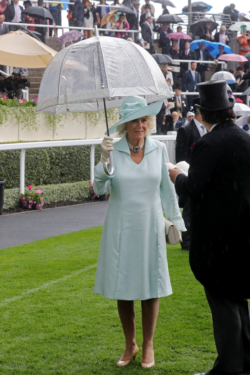 The Duchess of Cornwall looked elegant in an aqua long-sleeved dress with a matching hat, nude accessories and her aquamarine three-strand pearl necklace. <em>[Photo: Getty]</em>