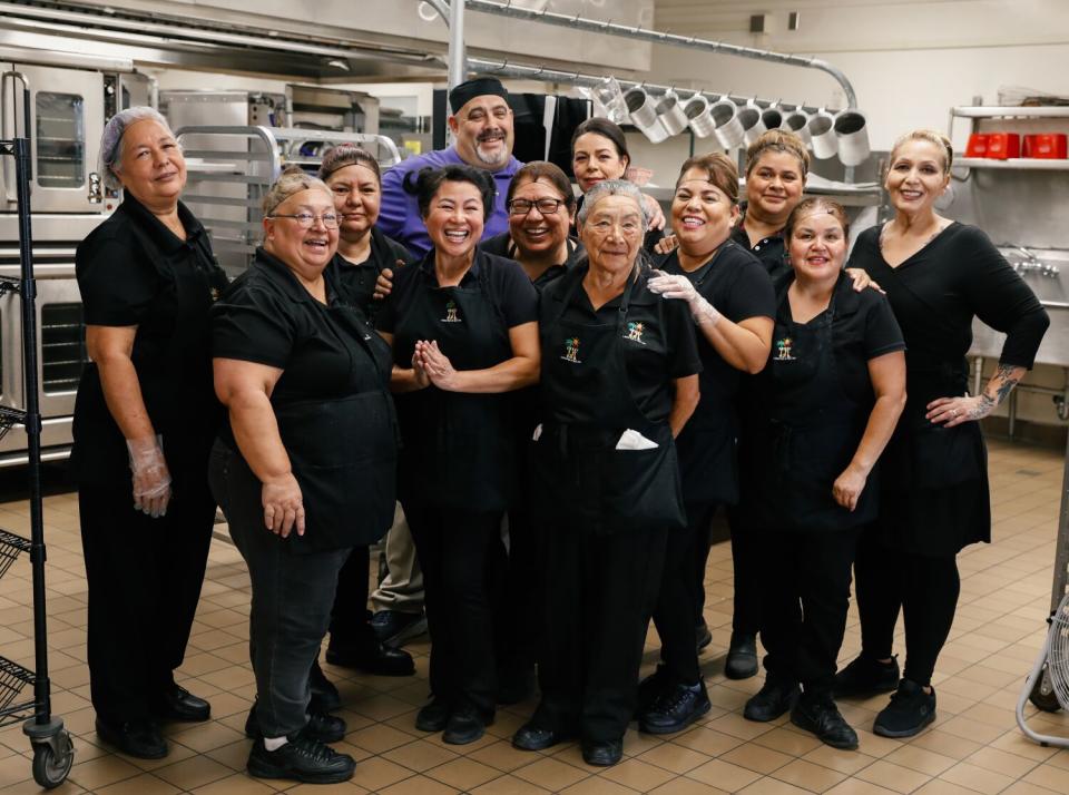 Kitchen workers gather for a group photo.