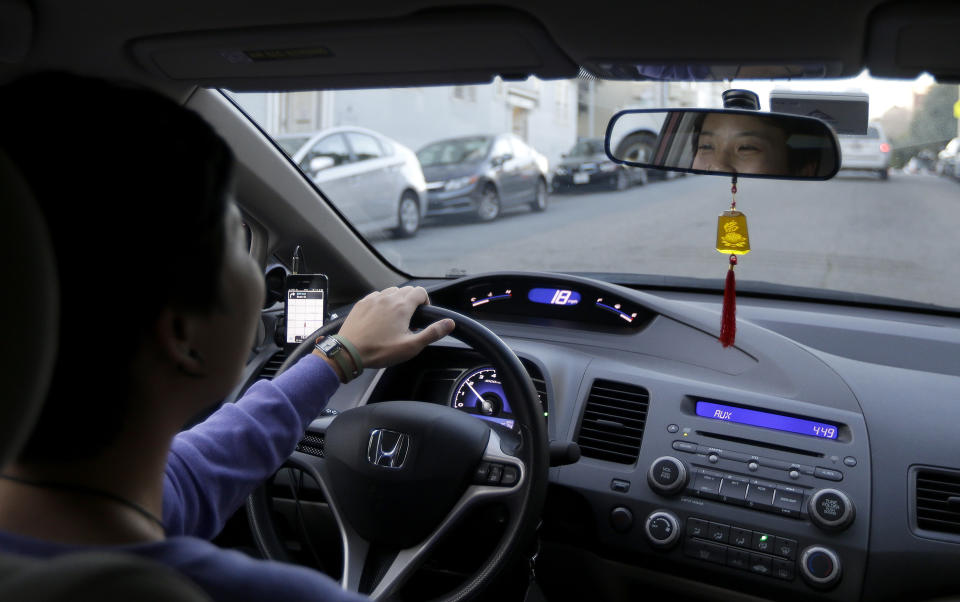 In this Jan. 4, 2013 photo, Lyft driver Nancy Tcheou drives in San Francisco, Friday. Fed up with traditional taxis, city dwellers are tapping their smartphones to hitch rides from strangers using mobile apps that allow riders and drivers to find each other. Internet-enabled ridesharing services such as Lyft, Uber and Sidecar are expanding rapidly in San Francisco, New York and other U.S. cities, billing themselves as a high-tech, low-cost alternative to cabs. (AP Photo/Jeff Chiu)