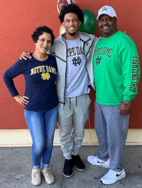 Notre Dame freshman cornerback Jaden Mickey (center) with his parents Nilka and Lamar on early signing day in December 2021