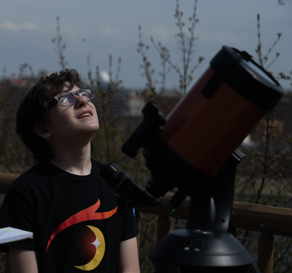 Mayson Howell, 13, of Troy, Missouri, looks up at the sky Monday before the total eclipse at the Akron Zoo.
