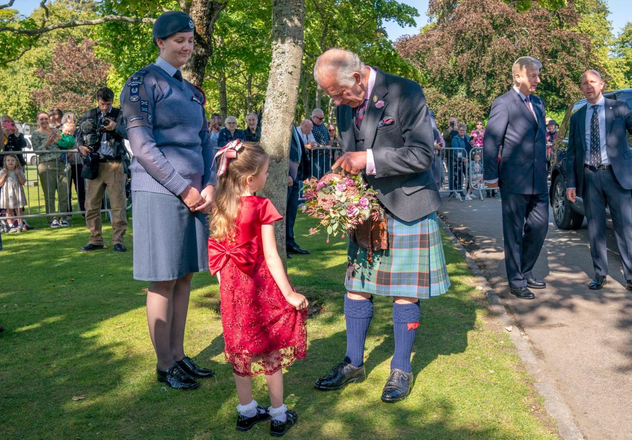 The King receives flowers from Charlotte Keith, 5, after officially opening the Royal Horticultural Society of Aberdeen's 200th flower show