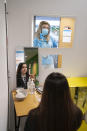 A student at Great Academy Ashton is taken through the Covid testing proceedure, as the school prepares for its reopening on March 8 after the latest lockdown curb the spread of coronavirus, in Ashton-Under-Lyne, England, Thursday, March 4, 2021. The school for approximately 1300 pupils aged 11 to 16 in Greater Manchester will have to conduct around 450 tests per day on pupils and staff in the first 2 weeks after the return of students on Monday. (AP Photo Jon Super)