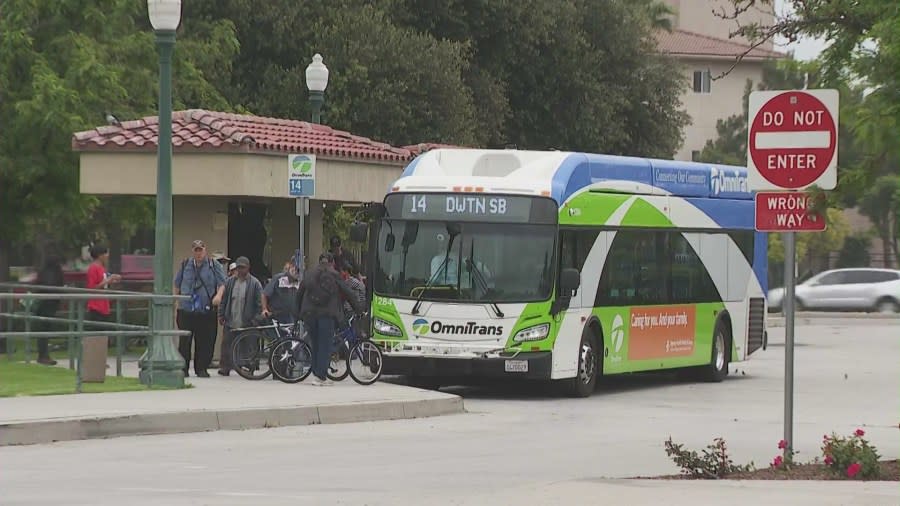 Riders waiting to board a Metro bus in Fontana, California. (KTLA)