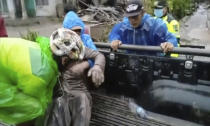 An injured man, covered in ash, is placed on a small truck to be taken to the hospital in the Lumajang District in Indonesia, on Saturday, Dec. 4, 2021 after Mount Semeru’s eruption. Indonesia's highest volcano on Java island has spewed thick columns of ash, searing gas and lava down its slopes in a sudden eruption triggered by heavy rains. (AP Photo)