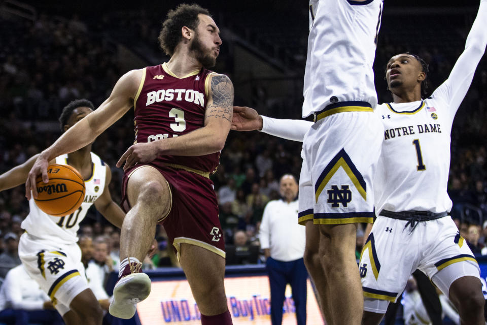 Boston College's Jaeden Zackery (3) passes behind his back as Notre Dame's Nate Laszewski, center, and JJ Starling (1) defend him during an NCAA college basketball game Saturday, Jan. 21, 2023 in South Bend, Ind. (AP Photo/Michael Caterina)