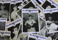 FILE - This April 25, 2013 file photo shows an old image of Conrado Marrero, center, sitting on top of a collection of photos of his former teammates from the Cuban baseball team Almendares, at his home in Havana, Cuba. Family members say Marrero has died in Havana. He was 102, just two days short of his 103rd birthday. Grandson Rogelio Marrero confirmed the death on Wednesday, April 23, 2014. Marrero was a diminutive right-hander who went by the nickname "Connie" when he pitched for the Washington Senators in the 1950s. (AP Photo/Franklin Reyes, File)