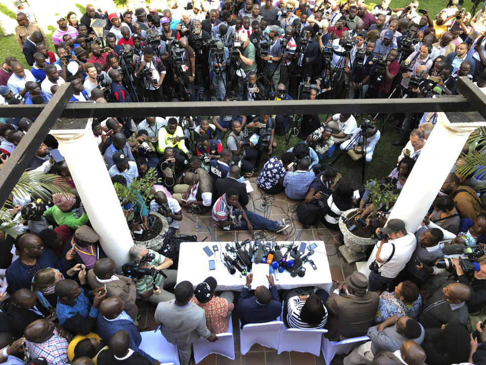 A press conference by opposition leader Nelson Chamisa gets underway in Harare, Zimbabwe, Friday Aug. 3, 2018. Hours after President Emmerson Mnangagwa was declared the winner of a tight election, riot police disrupted the press conference where opposition leader Nelson Chamisa was about to respond to the election results. (AP Photo/Jerome Delay)