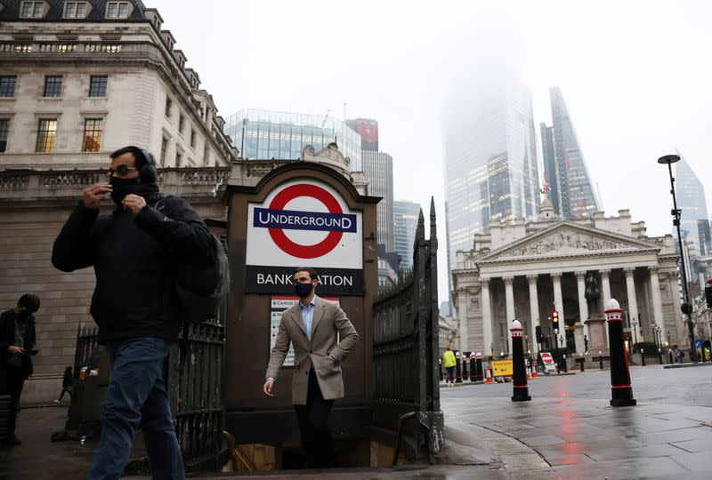 FILE PHOTO: People exit Bank station in the City of London financial district, amid the coronavirus disease (COVID-19) outbreak, in London