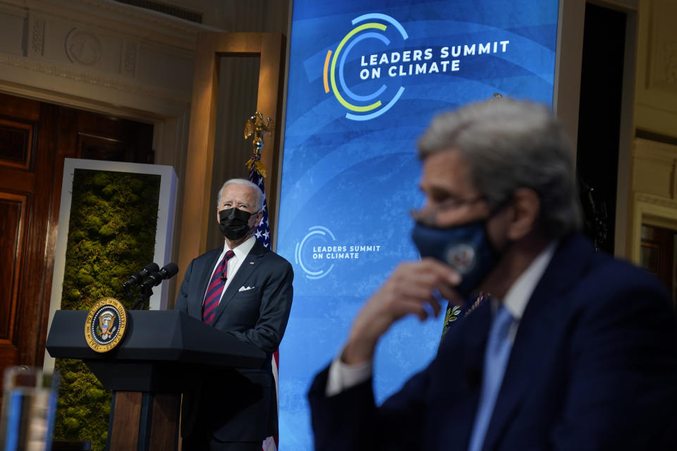 President Joe Biden speaks to the virtual Leaders Summit on Climate, from the East Room of the White House, Thursday, April 22, 2021, in Washington, as Special Presidential Envoy for Climate John Kerry, looks on. (AP Photo/Evan Vucci)