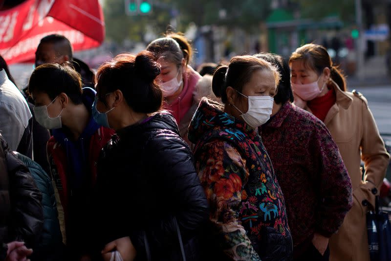 People wearing masks are seen in downtown Shanghai