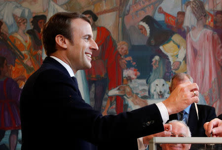 French presidential election candidate Emmanuel Macron, head of the political movement En Marche !, or Onwards !, casts his ballot to vote in the second round of 2017 French presidential election, at a polling station in Le Touquet, France, May 7, 2017. REUTERS/Christophe Ena/Pool