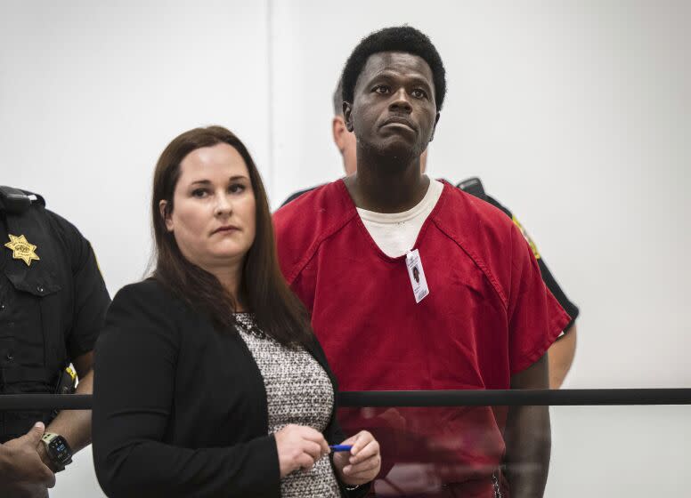 CORRECTS NAME OF COURT TO SAN JOAQUIN SUPERIOR COURT, INSTEAD OF STOCKTON SUPERIOR COURT - Wesley Brownlee stands with public defender Allison Nobert during his arraignment in San Joaquin County Superior Court on Tuesday, Oct. 18, 2022. Prosecutors have charged Brownlee with fatally shooting three men whom police have said were among six victims slain by a serial killer over the past year and a half. (Hector Amezcua/The Sacramento Bee via AP)