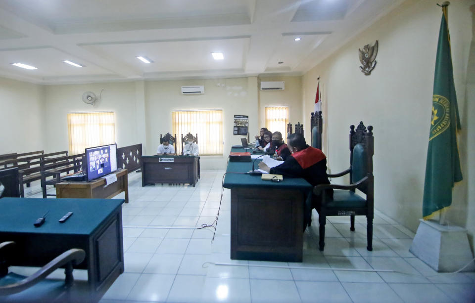 Judges read out their verdict during the virtual sentencing hearing for Papuan pro-independence activists who are on trial on the accusation of treason, at a district court in Balikpapan, East Kalimantan, Indonesia, Wednesday, June 17, 2020. The court sentenced the activists to nearly yearlong jail terms on treason charges for organizing anti-racism protests last year, despite calls from rights groups and politicians to drop the charges and release them. (AP Photo/Andi Muhammad Hafizh)