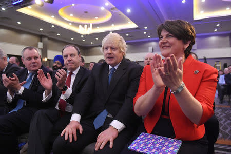 Democratic Unionist Party (DUP) leader Arlene Foster, and Deputy Leader Nigel Dodds, sit next to Conservative MP Boris Johnson, at the DUP annual party conference in Belfast, Northern Ireland November 24, 2018. REUTERS/Clodagh Kilcoyne