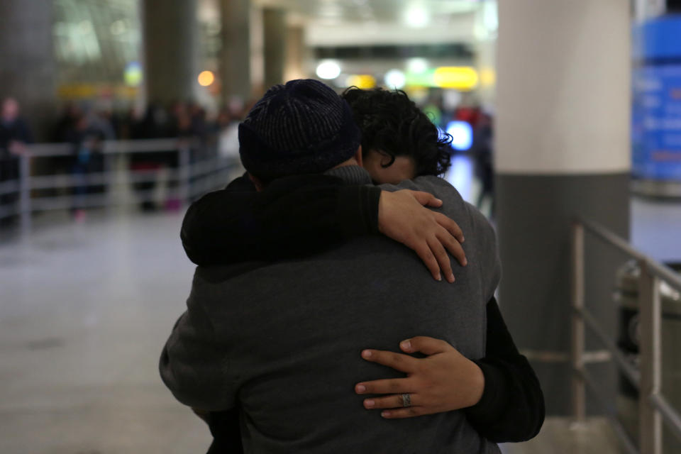 Ali Alghazali, 13, a Yemeni who was previously prevented from boarding a plane to the U.S., hugs his uncle Saleh Alghazali, upon Ali's arrival at Terminal 4 at JFK airport in Queens on Feb. 5, 2017, following the reprieve from the ban.