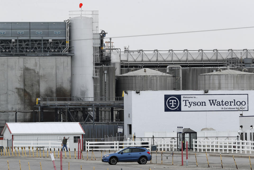 In this Friday, May 1, 2020, photo, a worker leaves the Tyson Foods plant in Waterloo, Iowa. The coronavirus is devastating the nation’s meatpacking communities — places like Waterloo and Sioux City in Iowa, Grand Island, Neb., and Worthington, Minn. Within weeks, the outbreaks around slaughterhouses have turned into full-scale disasters. (AP Photo/Charlie Neibergall)