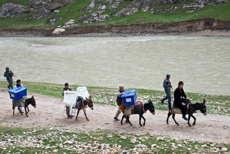 Donkeys help Afghan election workers transport ballot boxes and election materials to polling stations through Mazar-i-Sharif to Kishindih district in Balkh province, Afghanistan, Thursday, April 3, 2014. Elections will take place on Saturday. (AP Photo/Mustafa Najafizada)