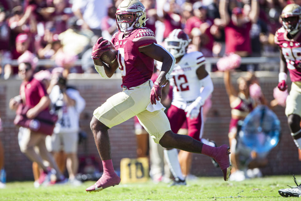 Florida State running back Jashaun Corbin (0) breaks through the line for a touchdown run in the first half of an NCAA college football game against Massachusetts in Tallahassee, Fla., Saturday, Oct. 23, 2021. (AP Photo/Mark Wallheiser)