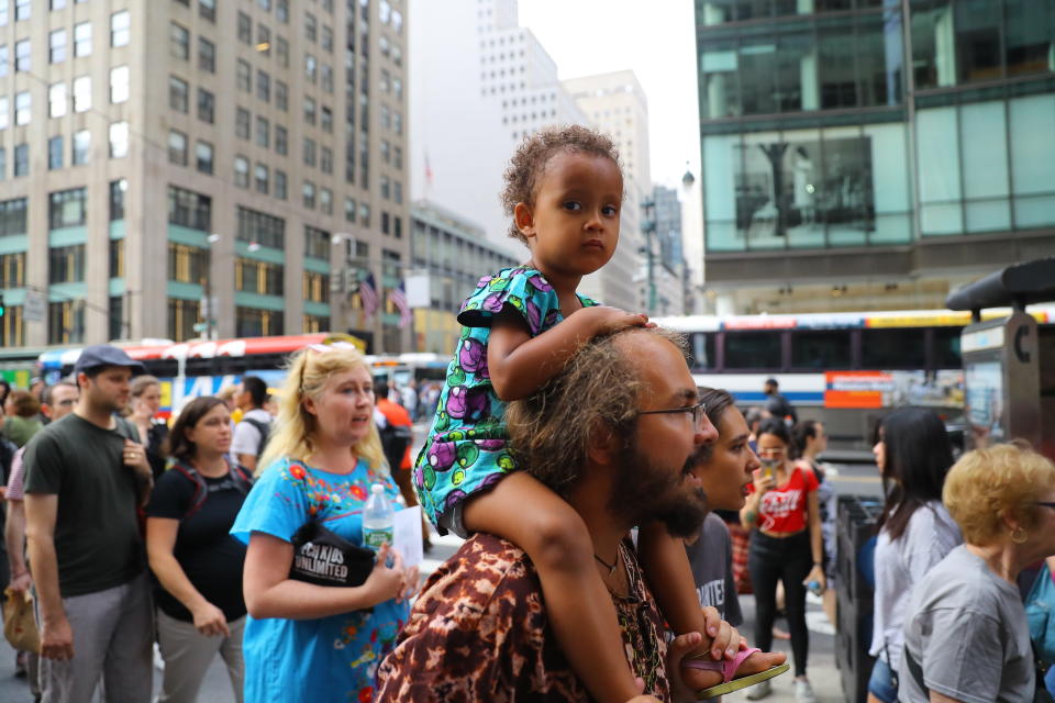 <p>A youngster gets a ride on Dad’s shoulders during a protest against the U.S. immigration policies in New York City on June 20, 2018. (Photo: Gordon Donovan/Yahoo News) </p>