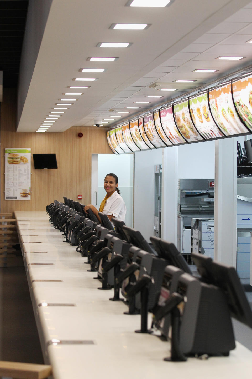 LONDON, ENGLAND - JUNE 25: Assistant manager Rachel Lucien stands at the checkouts in the world's largest McDonald's restaurant which is their flagship outlet in the Olympic Park on June 25, 2012 in London, England. The restaurant, which is one of four McDonald's to be situated within the Olympic Park, will have a staff of 500. After the Olympic and Paralympic Games conclude the restaurant will be dismantled and all fixtures and fittings will be either reused or recycled. (Photo by Oli Scarff/Getty Images)