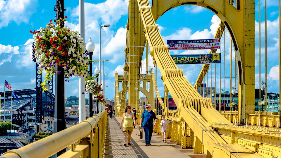 Pittsburgh, Pennsylvania, United States - July 31, 2016: Pedestrians crossing the Roberto Clemente Bridge on a beautiful summer day.