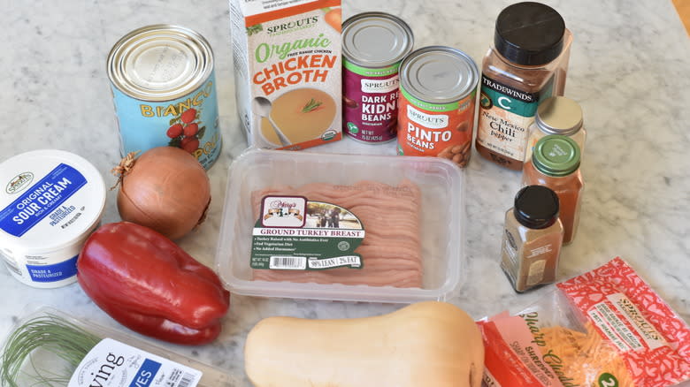 ingredients for turkey butternut chili on marble counter