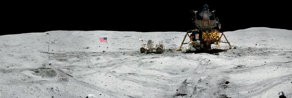 Apollo 16 commander Astronaut John W. Young works on the Lunar Roving Vehicle before it is deployed on the Apollo Lunar Surface Experiments Package during the first moonwalk of the Apollo 16 mission.