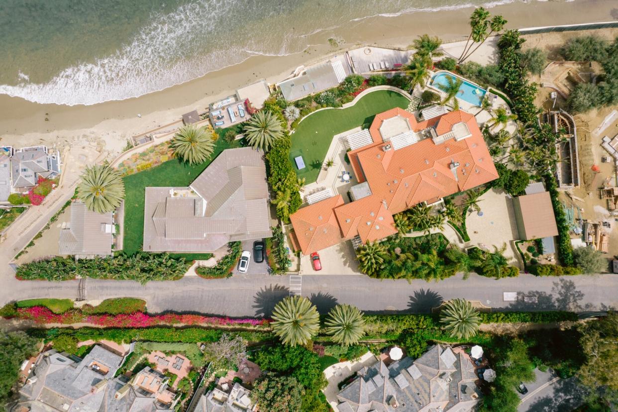 Aerial over houses along beach