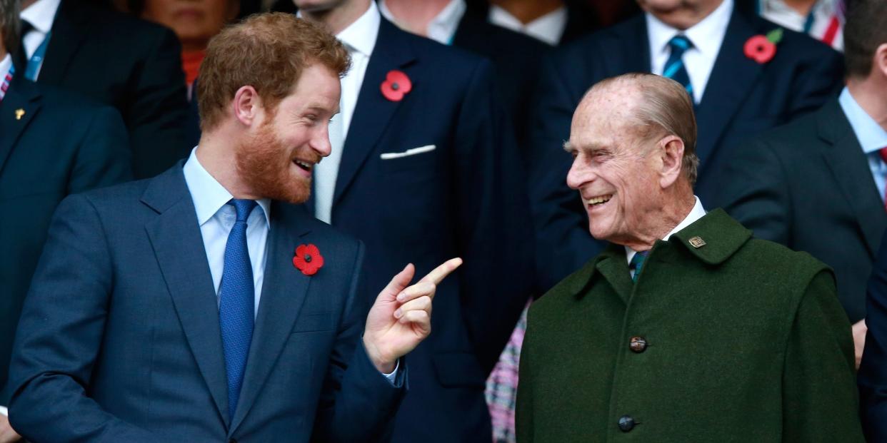 Prince Harry and Prince Phillip enjoy the atmosphere during the 2015 Rugby World Cup Final match between New Zealand and Australia at Twickenham Stadium on October 31, 2015 in London, United Kingdom.