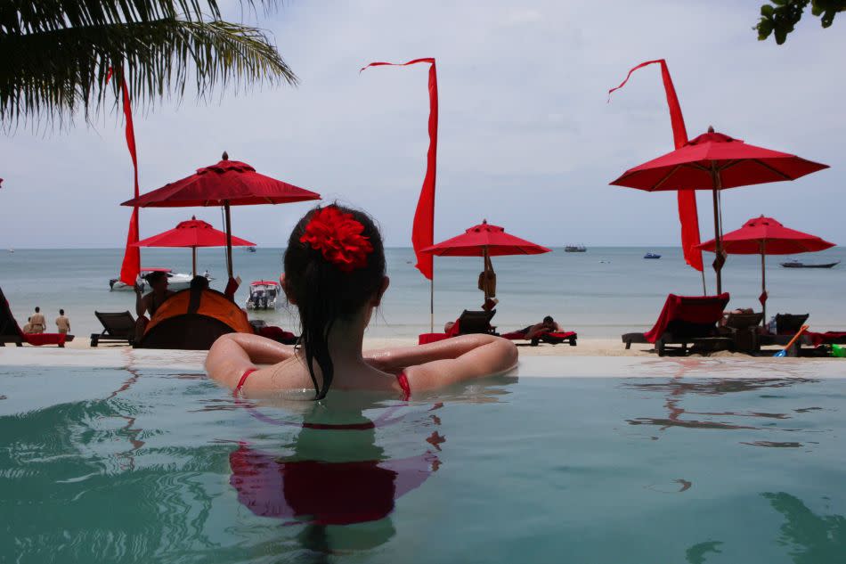 A woman enjoys the beachside pool at the Anantara Rasananda resort on the island of Koh Phangan off the coast of Koh Samui.