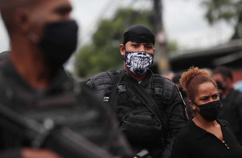 Police officers patrol the Alemao slums complex after an operation against drug gangs in Rio de Janeiro