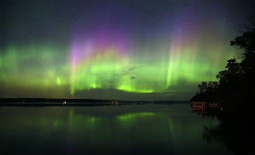 Northern Lights illuminate the sky over Lake Elora in northern Minnesota early Sunday morning, July 15, 2012. (AP Photo/The Star Tribune, Brian Peterson)