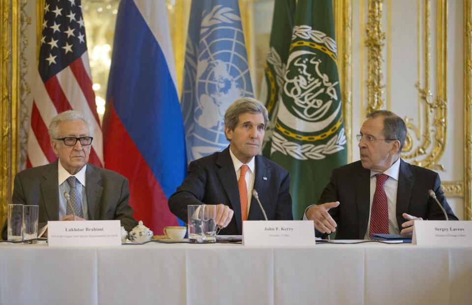US Secretary of State John Kerry, center, with Russia's Foreign Minister Sergey Lavrov, right, and U.N-Arab League envoy for Syria Lakhdar Brahimi, left, before the start of their meeting at the US Ambassador's residence in Paris, France, Monday, Jan. 13, 2014. Kerry is in Paris for meetings on Syria to rally international support for ending the three-year civil war in Syria. (AP Photo/Pablo Martinez Monsivais, Pool)