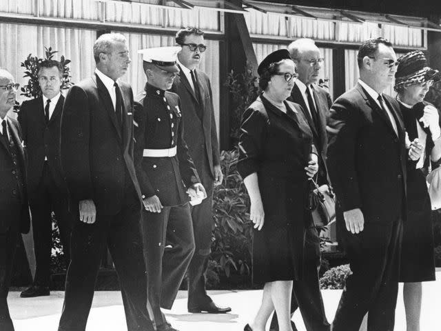 <p>Keystone/Getty</p> Joe DiMaggio attends the funeral of film star Marilyn Monroe with his son Joe Junior and Monroe's half-sister Bernice Miracle.