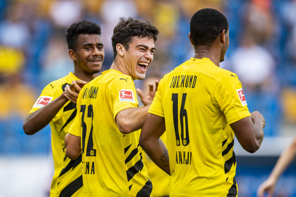 From left, Dortmund's Ansgar Knauff, Giovanni Reyna and Manuel Akanji celebrate after a goal.