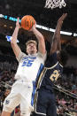 Creighton's Baylor Scheierman (55) puts up a shot with Akron's Ali Ali defending during the first half of a first-round college basketball game in the NCAA Tournament, in Pittsburgh, Thursday, March 21, 2024. Creighton won 77-60. (AP Photo/Gene J. Puskar)