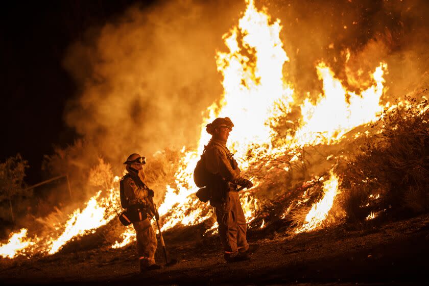 LAKE ELSINORE, CALIF. -- FRIDAY, AUGUST 10, 2018: Firefighters conduct a burn operation to remove fuel around homes on Grand Ave as the Holy Fire grows to more than 10,000 acres as the wildfire comes closer to Lake Elsinore, Calif., on Aug. 10, 2018. (Marcus Yam / Los Angeles Times)