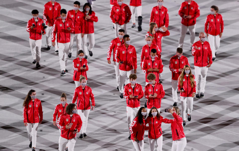 <p>TOKYO, JAPAN - JULY 23: Members of Team Canada lead their team out during the Opening Ceremony of the Tokyo 2020 Olympic Games at Olympic Stadium on July 23, 2021 in Tokyo, Japan. (Photo by Clive Brunskill/Getty Images)</p> 