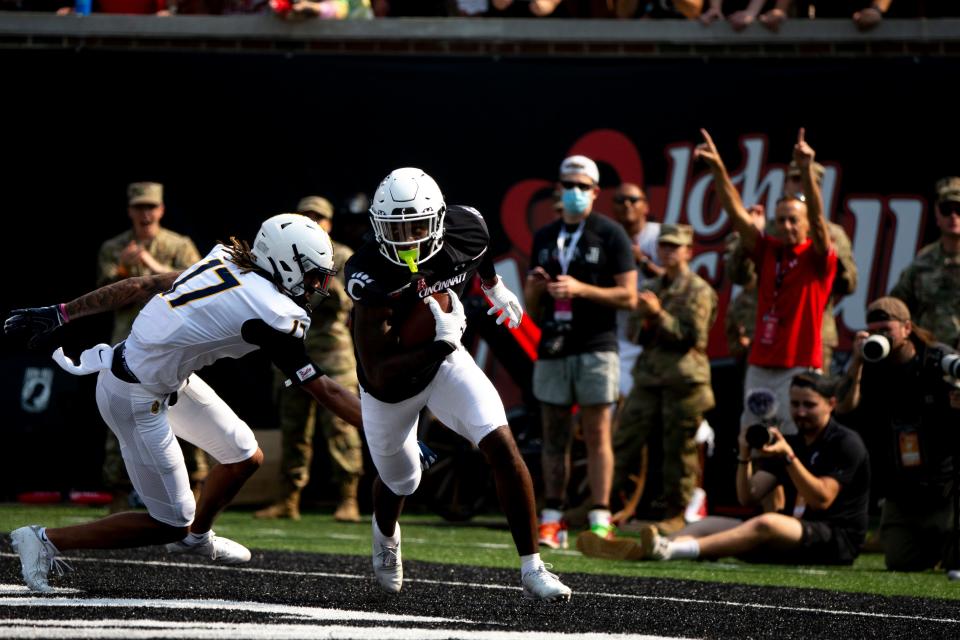 Cincinnati Bearcats safety Ja'von Hicks (3) intercepts a pass in the end zone as Murray State Racers wide receiver Jacob Bell (17) chases him in the first half of the NCAA football game between Cincinnati Bearcats and Murray State Racers on Saturday, Sept. 11, 2021, at Nippert Stadium in Cincinnati. 