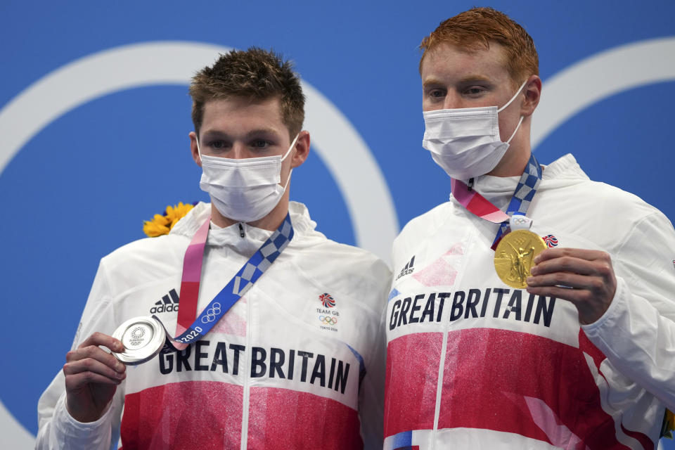 Gold medalist Tom Dean, right, of Britain poses with silver medalist and compatriot Duncan Scott after the men's 200-meter freestyle final at the 2020 Summer Olympics, Tuesday, July 27, 2021, in Tokyo, Japan(AP Photo/Matthias Schrader)
